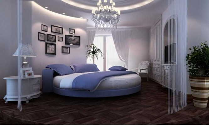 Černá kulatá postel s moderním designem, elegantními detaily a pohovkou