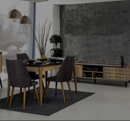 Jídelní skupina designéra hnědý jídelní stůl 4x černé čalouněné židle.